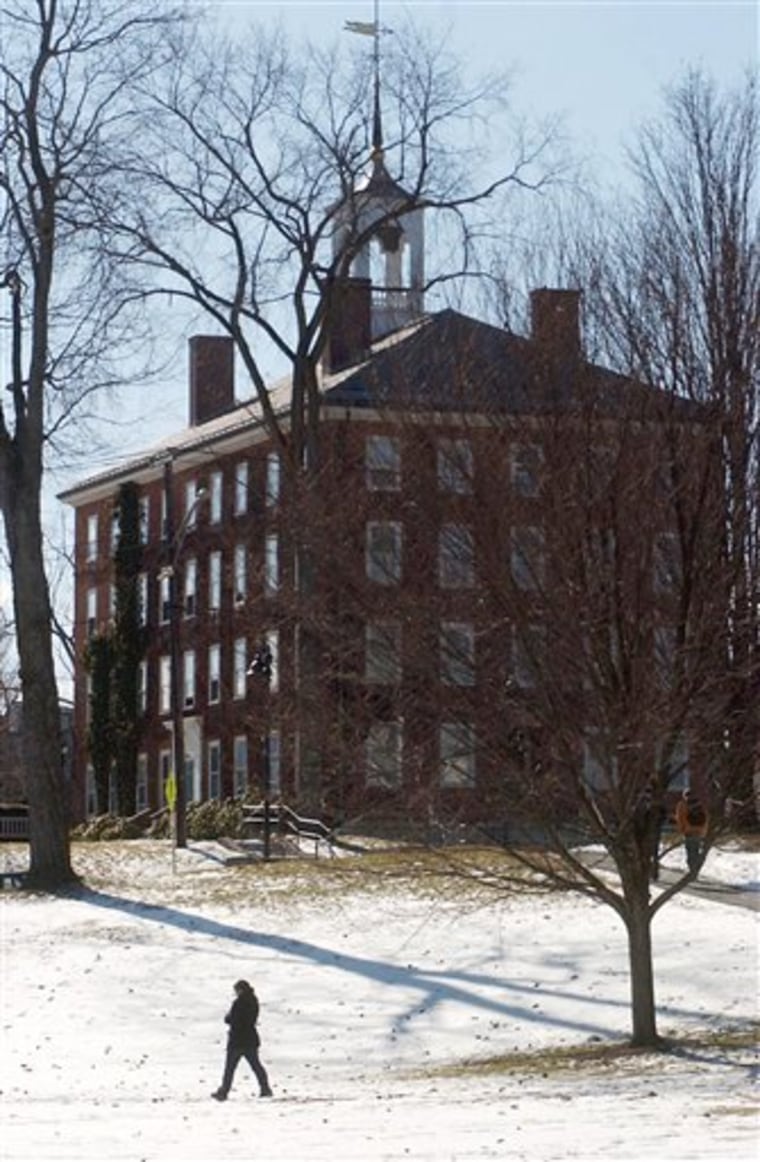 A person walks across the Williams College campus, in Williamstown, Mass. Williams and Dartmouth are cutting back aid packages, and other schools may do the same. 